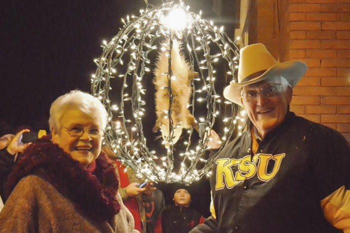 Bud and Jackie Jones pose near Spencer the stuffed opossum (in his lighted countdown ball) in Tallapoosa, Ga., in 2014.