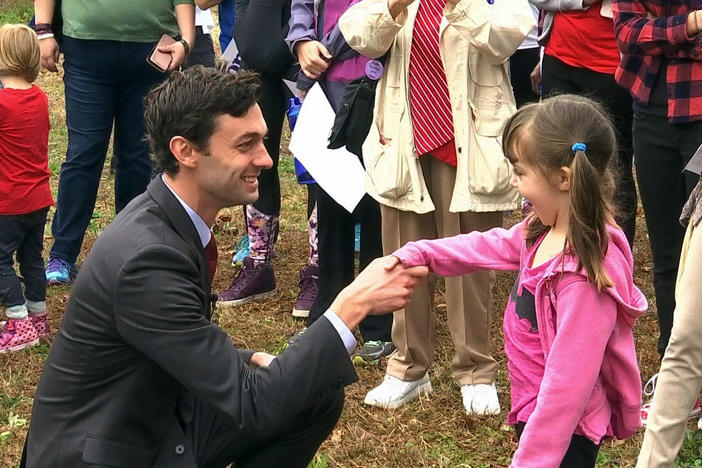 In a Monday, March 27, 2017 photo, Democratic congressional candidate Jon Ossoff is seen with supporters outside of the East Roswell Branch Library in Roswell, Ga., on the first day of early voting.
