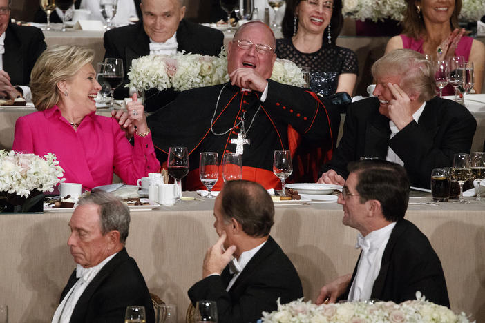 Republican presidential candidate Donald Trump, right, Cardinal Timothy Dolan, Archbishop of New York, center, and Democratic presidential candidate Hillary Clinton share a laugh during the Alfred E. Smith Memorial Foundation dinner, Oct. 20, 2016.