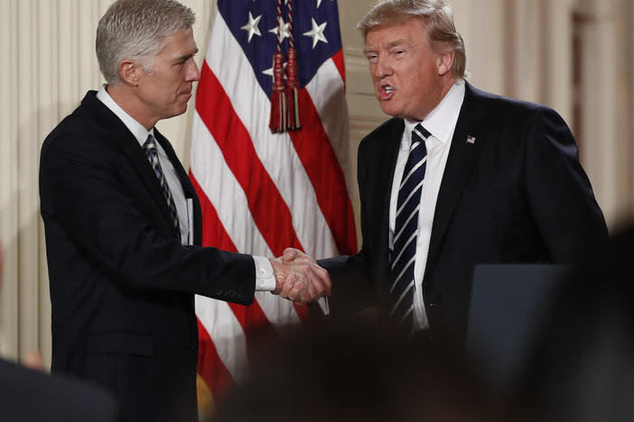 Judge Neil Gorsuch shakes hands with President Donald Trump as he is announced as Trump's choice for Supreme Court Justice during a televised address from the East Room of the White House in Washington, Tuesday, Jan. 31, 2017. 