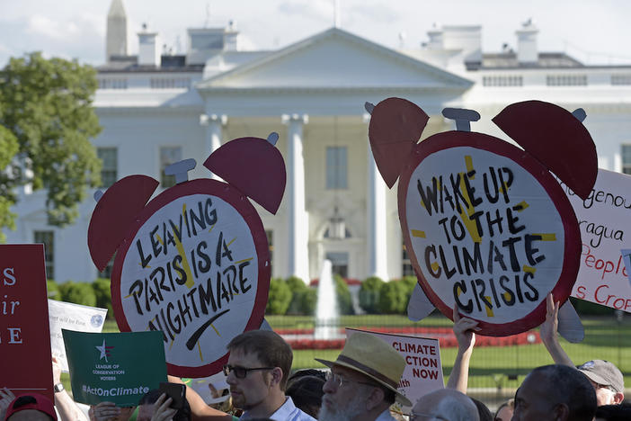 Protesters gather outside the White House in Washington, Thursday, June 1, 2017, to protest President Donald Trump's decision to withdraw the Unites States from the Paris climate change accord.