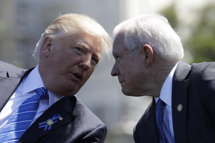 President Donald Trump talks with Attorney General Jeff Sessions, gestures before speaking at the 36th Annual National Peace Officers' memorial service, Monday, May 15. 2017, on Capitol Hill in Washington. 