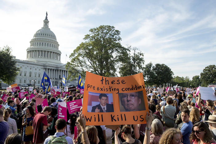 People rally against the Senate Republican health care bill on the East Front of the Capitol in Washington, Wednesday, June 28, 2017. 