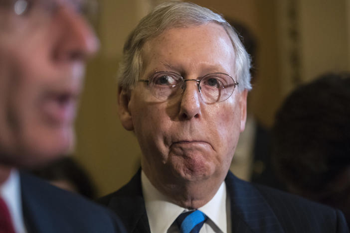 In this July 11, 2017 file photo, Senate Majority Leader Mitch McConnell of Ky. listens as Sen. John Barrasso, R-Wyo. speaks during a news conference on Capitol Hill in Washington.