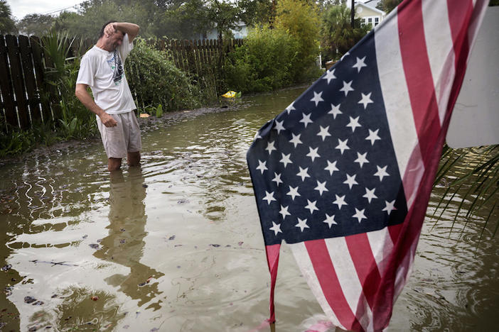 Tybee Island resident Joe Murphy wipes the sweat off his face while standing in knee deep water from Tropical Storm Irma outside his house, Monday, Sept., 11, 2017, on Tybee Island, Ga. 