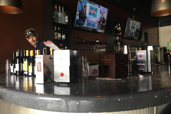 Miramar Raw Bar & Tapas bar manager Josh Howard stocks liquor at the new restaurant that is opening Feb. 13 on Forsyth Road in North Macon