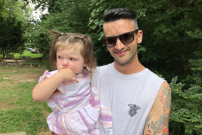 Rob Petrecca holds his 2-year-old daughter. Petrecca has been in recovery from substance use disorder since February 2018.