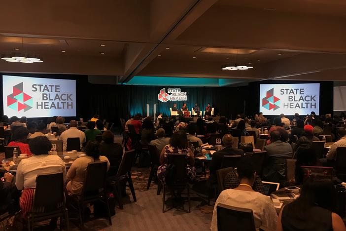 People listen to a panel on the first day of the State of Black Health conference. 