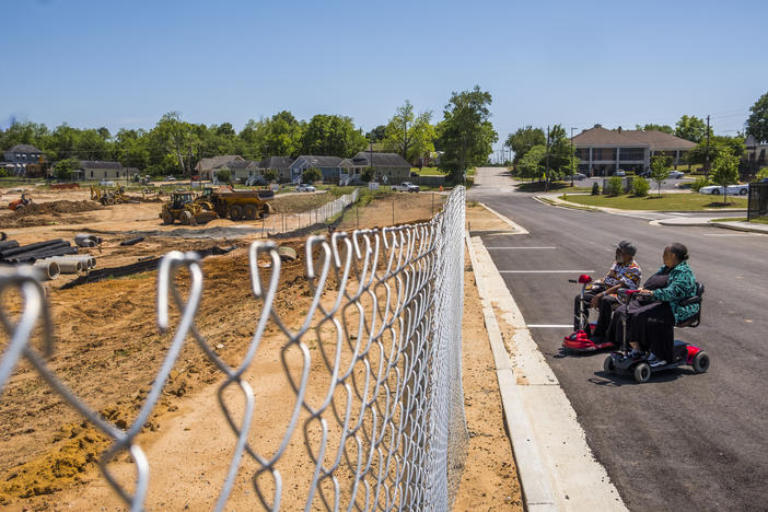 Teola Scndezera and her husband Emmanuel Scndezera spend time on most days watching the construction of the mixed income housing that will neighbor the subsidized Tindall Senior Towers where they live.