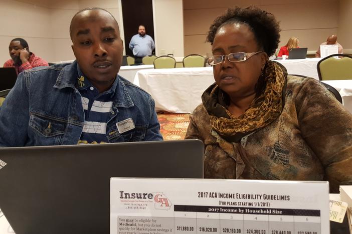 ACA navigator Ted Hall guides Lizella's Donna Hughes as she renews her insurance under the Affordable Care Act. This happened during a one-day event at the Macon Centerplex.