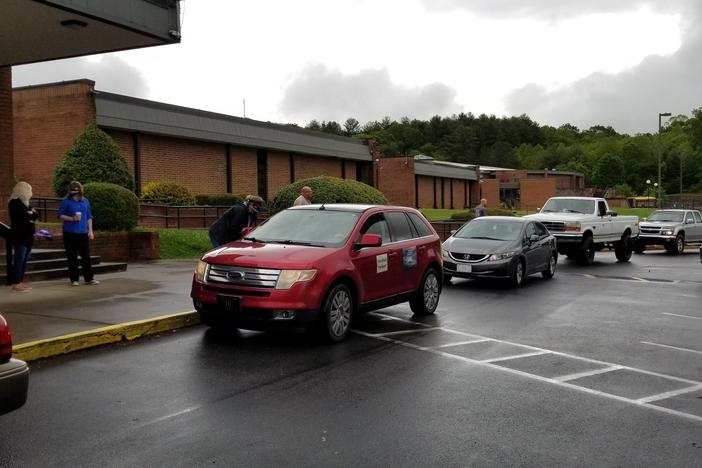 Students from Towns County High School pick up their caps and gowns Friday prior to a senior parade.