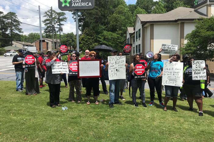 Uber and Lyft drivers in Atlanta participate in global protest against the rideshare companies ahead of Uber's IPO.
