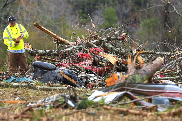 Bob Wright looks for personal belongings after a suspected tornado ripped through the town of Rosalie, killing three of his brother's family members, Wednesday, Nov. 30, 2016, in Rosalie, Ala. 