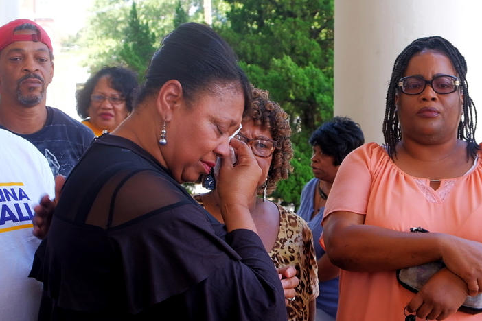 Macon NAACP chapter president Gwen Westbrook wipes away tears before a press conference where she asked for a curfew for teens to stem homicides. 