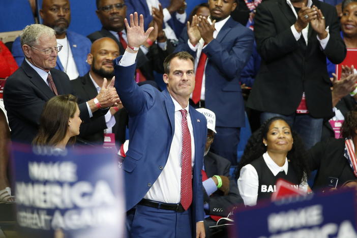 Oklahoma Gov. Kevin Stitt attends President Trump's campaign rally last month in Tulsa. Stitt dismisses the notion that he became infected at the June 20 event, saying it was too long ago.