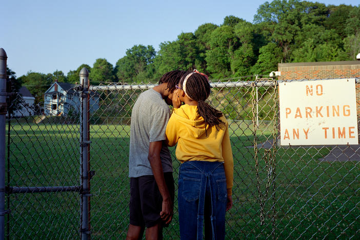 Photographer Nadiya Nacorda's siblings Khaya (left) and Thandiswa whispering at at fence.