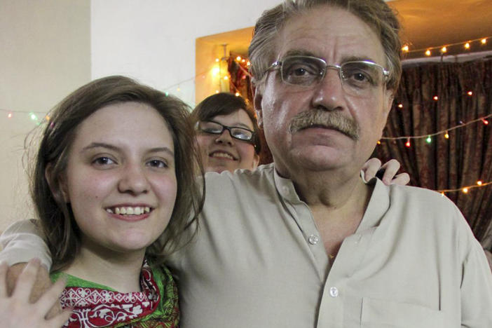 Idris Khattak disappeared in November. He is pictured with daughters Talia Khan and Shumaisa (in the background), on July 29, 2015, in Islamabad.