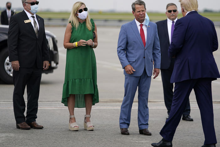 Georgia Gov. Brian Kemp (third from left) greets President Trump at Hartsfield-Jackson Atlanta International Airport on Wednesday.