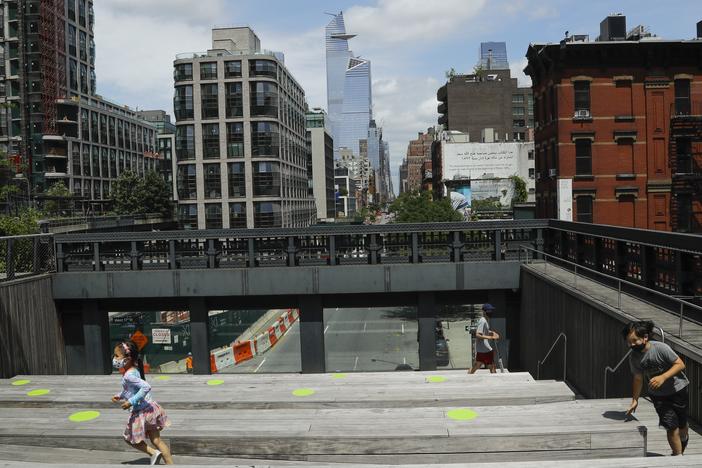 New York City Mayor Bill de Blasio announced that the city will offer free child care to 100,000 students when schools reopen for part-time in-person instruction in September. Here, children play at Manhattan's High Line park on Thursday.
