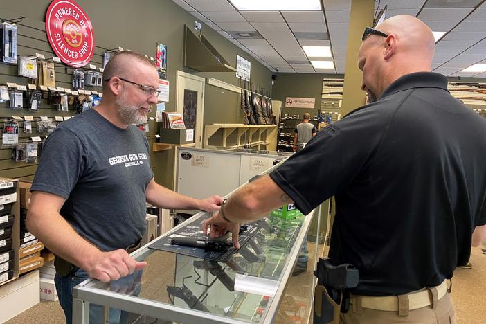 "Most of it is is new gun owners," says Michael Weeks (left), a gun store owner in Gainesville, Ga. By one estimate, Americans have bought nearly 3 million more guns than usual since March.