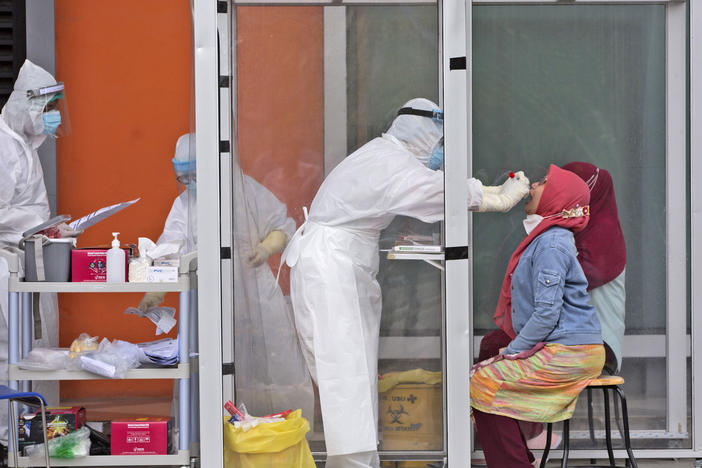 A medical worker collects nasal swab samples this week during a mass test for the coronavirus at North Sumatra University in Medan, North Sumatra, Indonesia. The mass test was held after the rector of the university along with one of his deputies and a member of the board of trustees were tested positive for COVID-19.