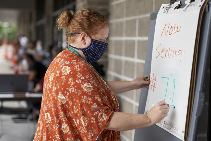 Vickie Gregorio with Heartland Workforce Solutions in Omaha, Neb., updates a whiteboard outside the workforce office as unemployed job seekers wait in line for help. A recent change in federal rules gives some people who have lost their health plan along with their job more than the usual 60 days to sign up for COBRA health coverage.