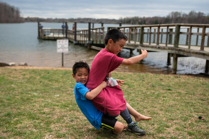 Hayle tackles Henry during a game of football Black Hill Regional Park in Boyds, Md., on April 7, 2019.