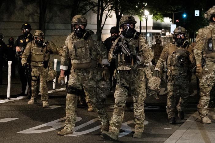 Federal officers prepare to disperse the crowd of protesters outside the Multnomah County Justice Center on July 17 in Portland. The use of federal agents has only made a bad situation worse, state and local officials told NPR.
