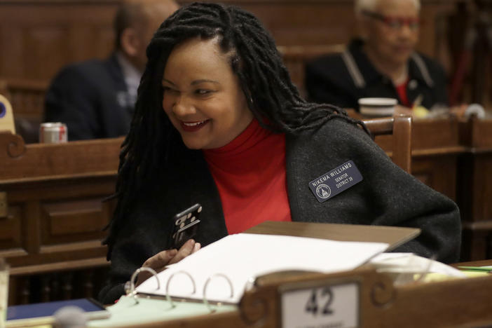 Georgia state Sen. Nikema Williams confers with a colleague on the floor of the Georgia Senate in February.