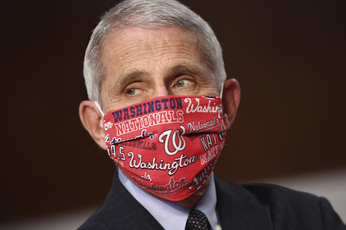 Dr. Anthony Fauci, director of the National Institute for Allergy and Infectious Diseases wore a Washington Nationals face mask before testifying at a congressional hearing on June 30. The team announced he will throw out the ceremonial first pitch at their season opener on Thursday.