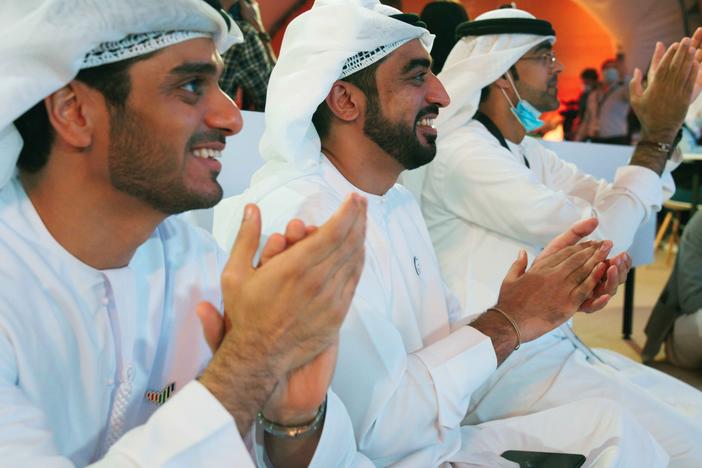 Emirati men clap as they watch the launch of the "Amal" or "Hope" space probe at the Mohammed bin Rashid Space Center in Dubai, United Arab Emirates, on Monday. The probe, the country's first interplanetary spacecraft, was launched from Japan.