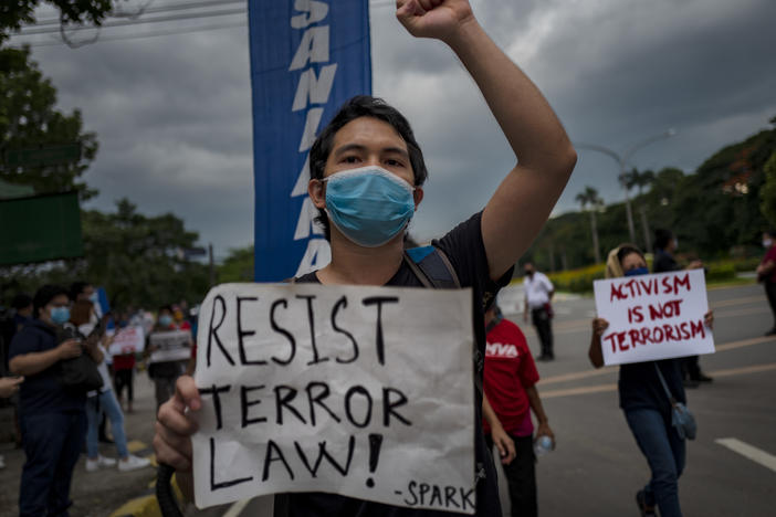 A protester wearing a face mask demonstrates against the Philippines' new anti-terrorism law on July 4, in Quezon city, Metro Manila. Earlier this month, President Rodrigo Duterte approved a law that critics say could lead to more human rights abuses.