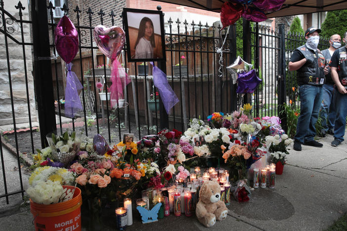 Candles burn in front of a memorial for Lena Nunez, 10, on June 29 in Chicago. The child was shot and killed by a stray bullet while watching TV with her brother in her grandmother's home, reports say.