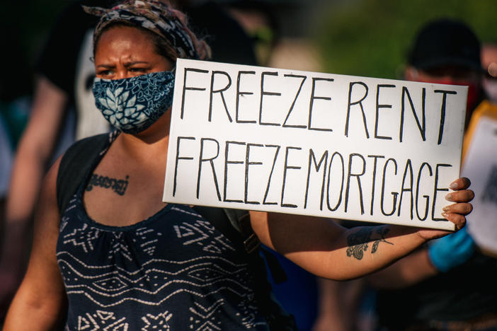 A woman joins with other demonstrators during the "Cancel Rent and Mortgages" rally in late June in Minneapolis. The march was demanding the temporary cancellation of rents and mortgages as COVID-19 batters the economy.