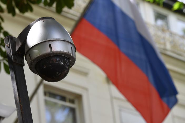 A security camera and flag adorn the entrance to the Russian Embassy in London. On Tuesday, lawmakers slammed the British government for failing to look into possible Russian interference in U.K. politics.