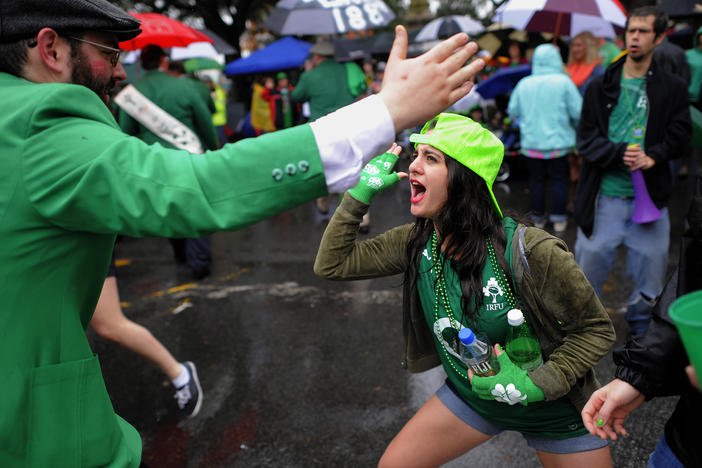 In this March 17, 2014 file photo, Andrea Sicignano of Long Island, N.Y., right, high-fives a participant marching in Savannah's 190-year-old St. Patrick's Day parade in Savannah, Georgia.