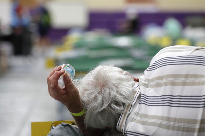 An evacuee lies on a cot at an evacuation shelter for people with disabilities in Stuart, Fla., in preparation for Hurricane Dorian on Sept. 1, 2019. Now, with the pandemic raging, officials across the South are trying to adjust their evacuation and shelter plans.