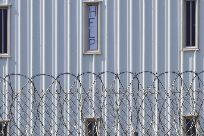 Holman Correctional Facility is one of the Alabama prisons that the Justice Department alleges inmates are subjected to excessive force by prison staff. This photo, taken in 2019, shows a sign that reads, "HELP," in the window of an inmate cell seen during a tour with state officials.