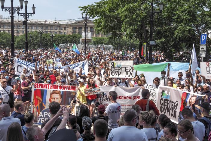 People in the city of Khabarovsk hold posters with messages demanding freedom for Sergei Furgal, the former governor of Russia's Khabarovsk region, on July 18. Protesters have taken to the streets over Furgal's arrest this month on murder charges, which he denies.