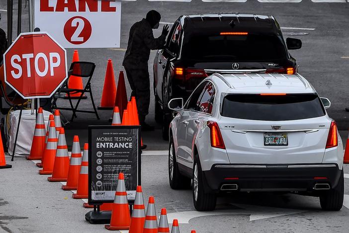 People wait for a COVID-19 test Wednesday at a walk-in and drive-through coronavirus testing site in Miami Beach, Fla. Miami-Dade County is the epicenter of the pandemic in Florida.