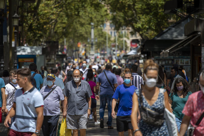 People walk along the Ramblas last week in Barcelona, Spain. The country has seen cases of the coronavirus spike in recent weeks.