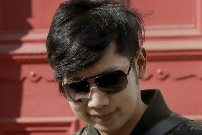 Vorayuth "Boss" Yoovidhya, whose grandfather co-founded energy drink company Red Bull, walks to get in a car as he leaves a house in London, in April 2017. Charges have been dropped against the Thai heir to the Red Bull energy drink fortune who is accused in a 2012 car crash that killed a Bangkok police officer.