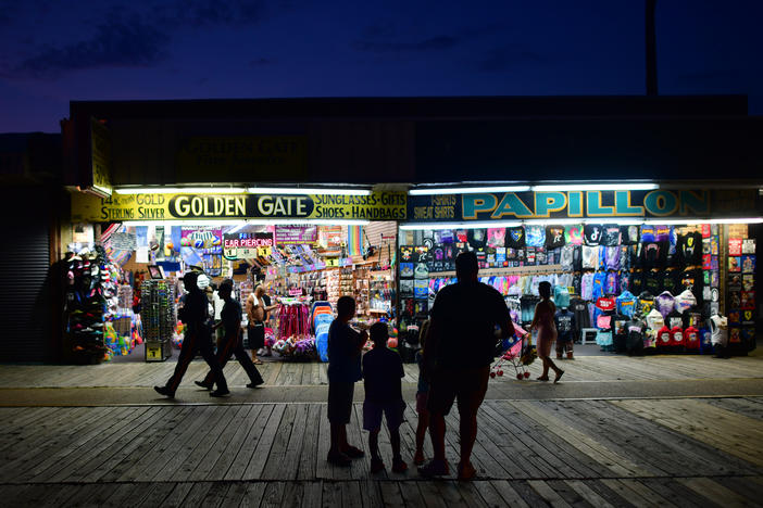 People walk the boardwalk in early July in Wildwood, N.J., after some coronavirus restrictions were lifted. There's concern that case counts could push back up in Mid-Atlantic and Northeastern states.