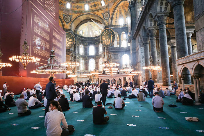 People gather to perform Friday prayers at Istanbul's Hagia Sophia for the first time in 86 years.