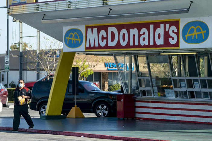 McDonald's will require all customers at its U.S. restaurants to wear a face mask, starting Aug. 1, the company says. Here, a customer wears a mask at the oldest operating McDonald's Corp. restaurant, in Downey, Calif., in April.