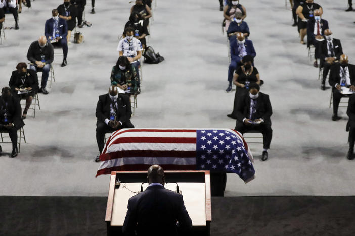 The Rev. Darryl Caldwell speaks as the casket of the late Rep. John Lewis, D-Ga., lies in repose during a service at Troy University in Troy, Ala., on Saturday.