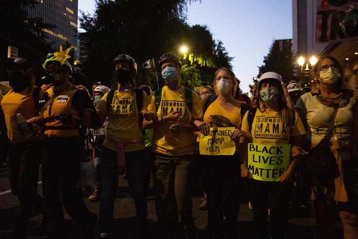 The Wall of Moms marches to the Multnomah County Justice Center in Portland, Ore., July 25, 2020. Portland has sustained protests against police brutality and systemic racism for 58 days.