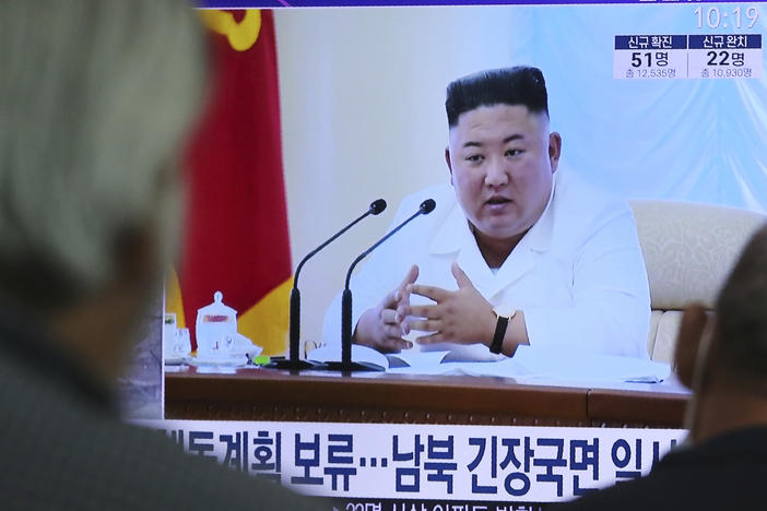 North Korean leader Kim Jong Un appears in a TV news program watched by people in Seoul, South Korea, on June 24.