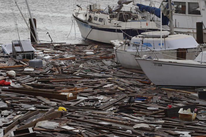 Broken boats and floating debris at a marina in Corpus Christi are among the damage caused by Hurricane Hanna, which was downgraded to a tropical storm and continued to shower Texas with heavy rain on Sunday.