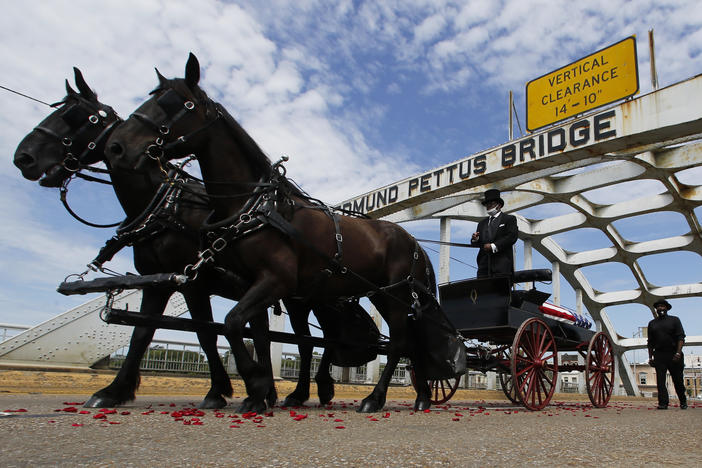 The casket of Rep. John Lewis crosses the Edmund Pettus Bridge by horse-drawn carriage during a memorial service for Lewis on July 26 in Selma, Ala.